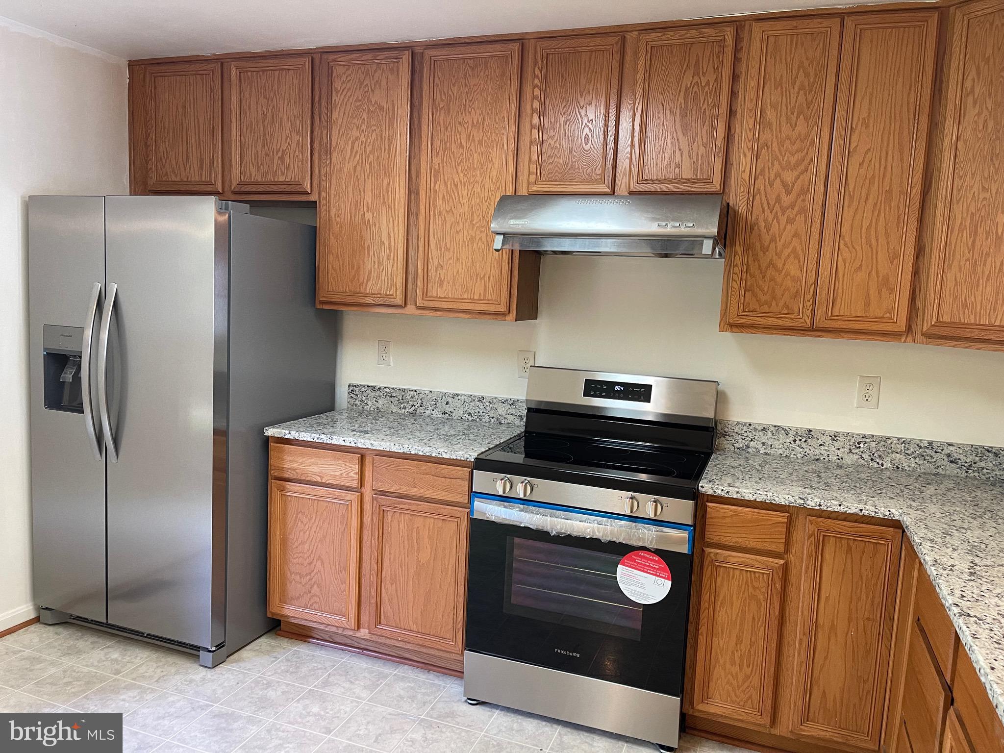 2017 Buell Drive Frederick, MD 21702 - Photo 9 of 23 a kitchen with granite countertop wooden cabinets sink and stainless steel appliances