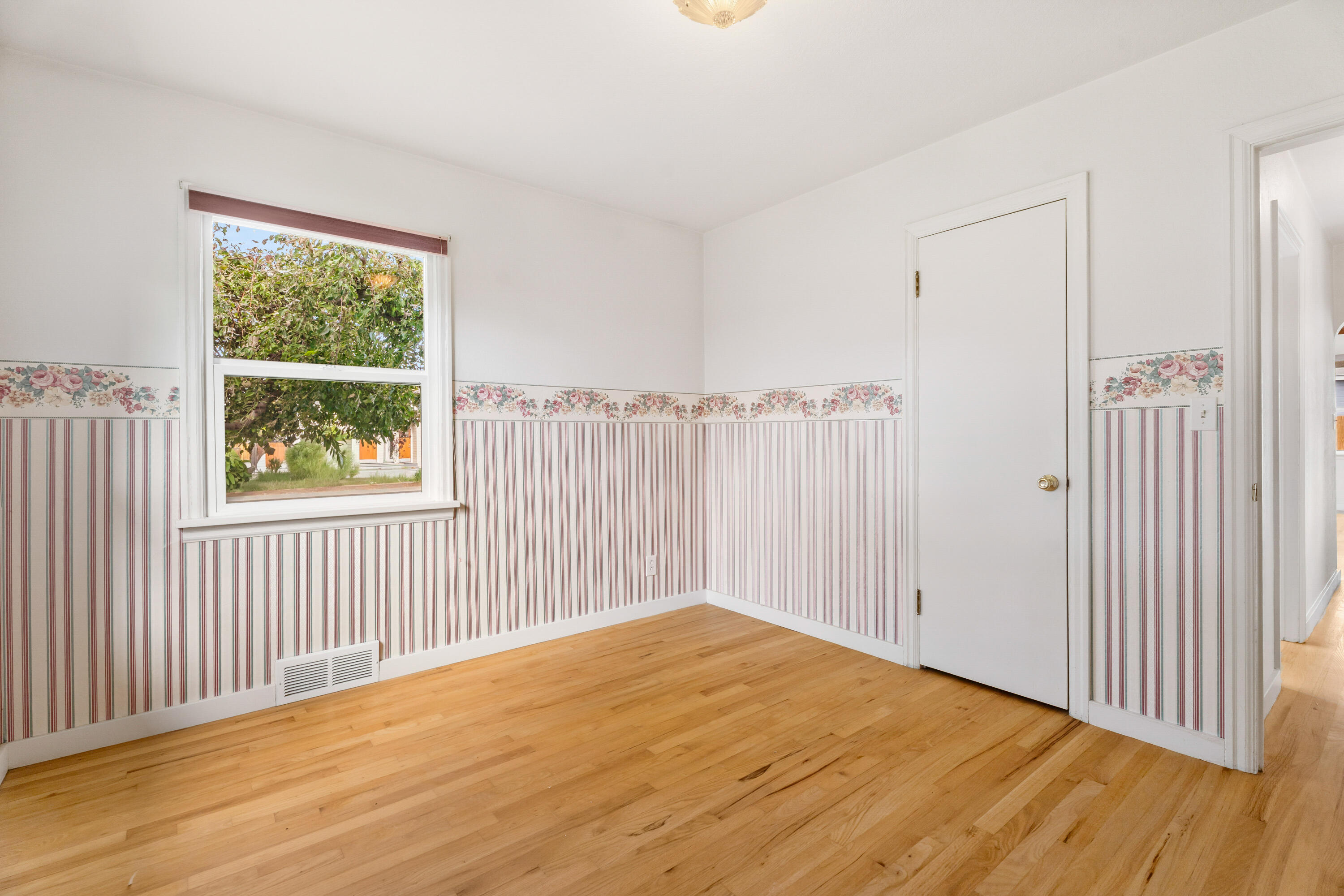 946 Southwest 13th Street Redmond, OR 97756 - Photo 33 of 49 a view of an empty room with wooden floor and a window