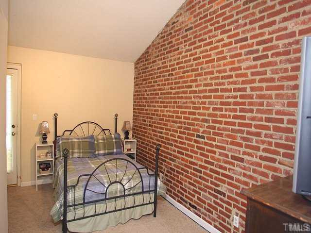 5418 Wayne Street Raleigh, NC 27606 - Photo 6 of 11 High Ceiling, Exposed Brick Wall, Back Door, NEW Carpet, Fresh Paint. Master Bedroom