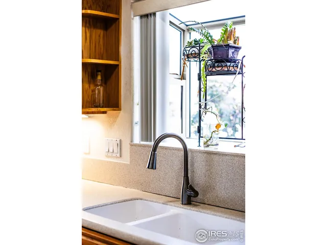 a kitchen with stainless steel appliances granite countertop a stove top oven a sink a counter space and cabinets