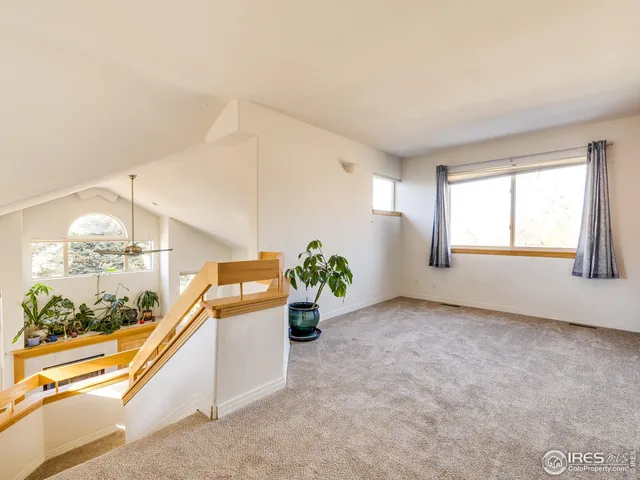 a room with a large window and bed