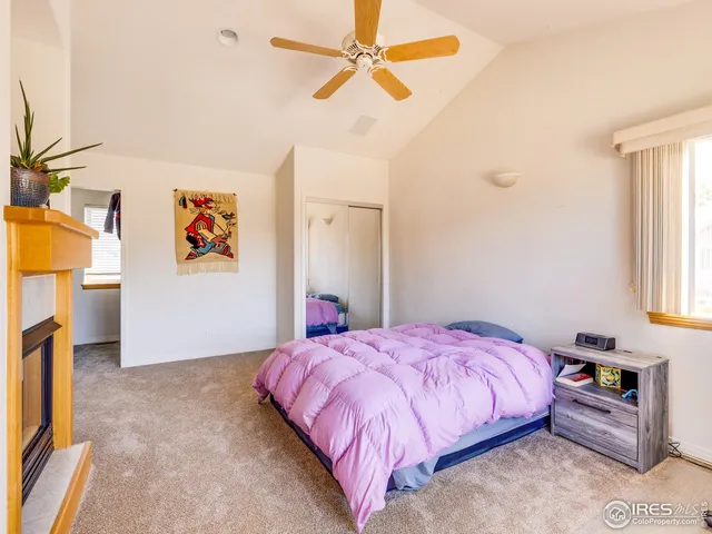 a bedroom with a bed and a fireplace