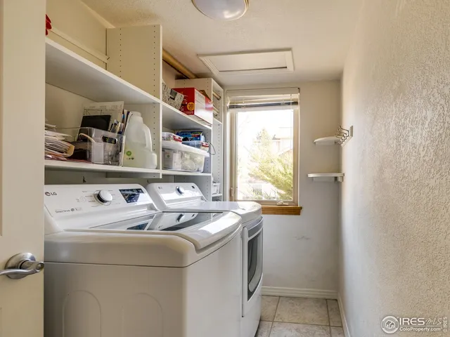 a bed room with a bed window and a chair