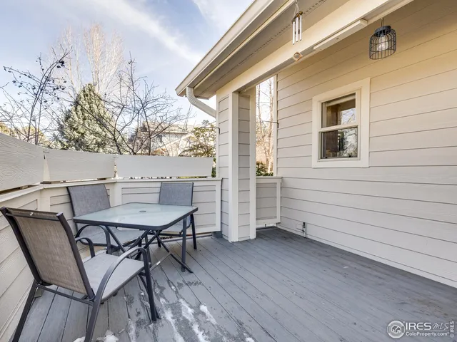 a view of a bench in balcony with wooden fence