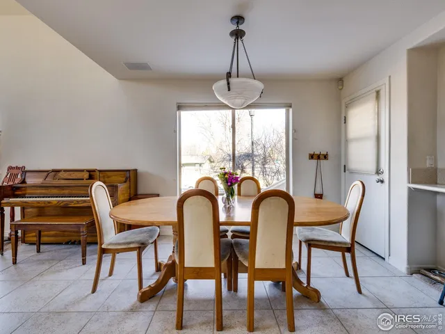 a kitchen with a table chairs and cabinets