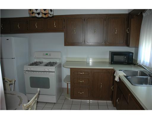 47 Emery Road Fredericktown, PA 15333 - Photo 8 of 12 Kitchen. Kitchen with gas stove, formica cabinets, and tile floor. Large double window lends a lot of natural light.