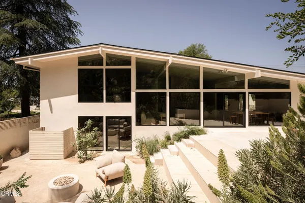 a view of a house with a large window and a yard