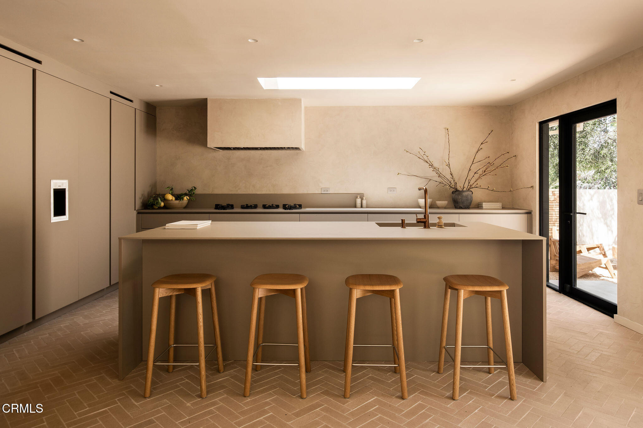 4722 Larkwood Avenue Los Angeles, CA 91364 - Photo 5 of 27 a white kitchen with a sink and chairs