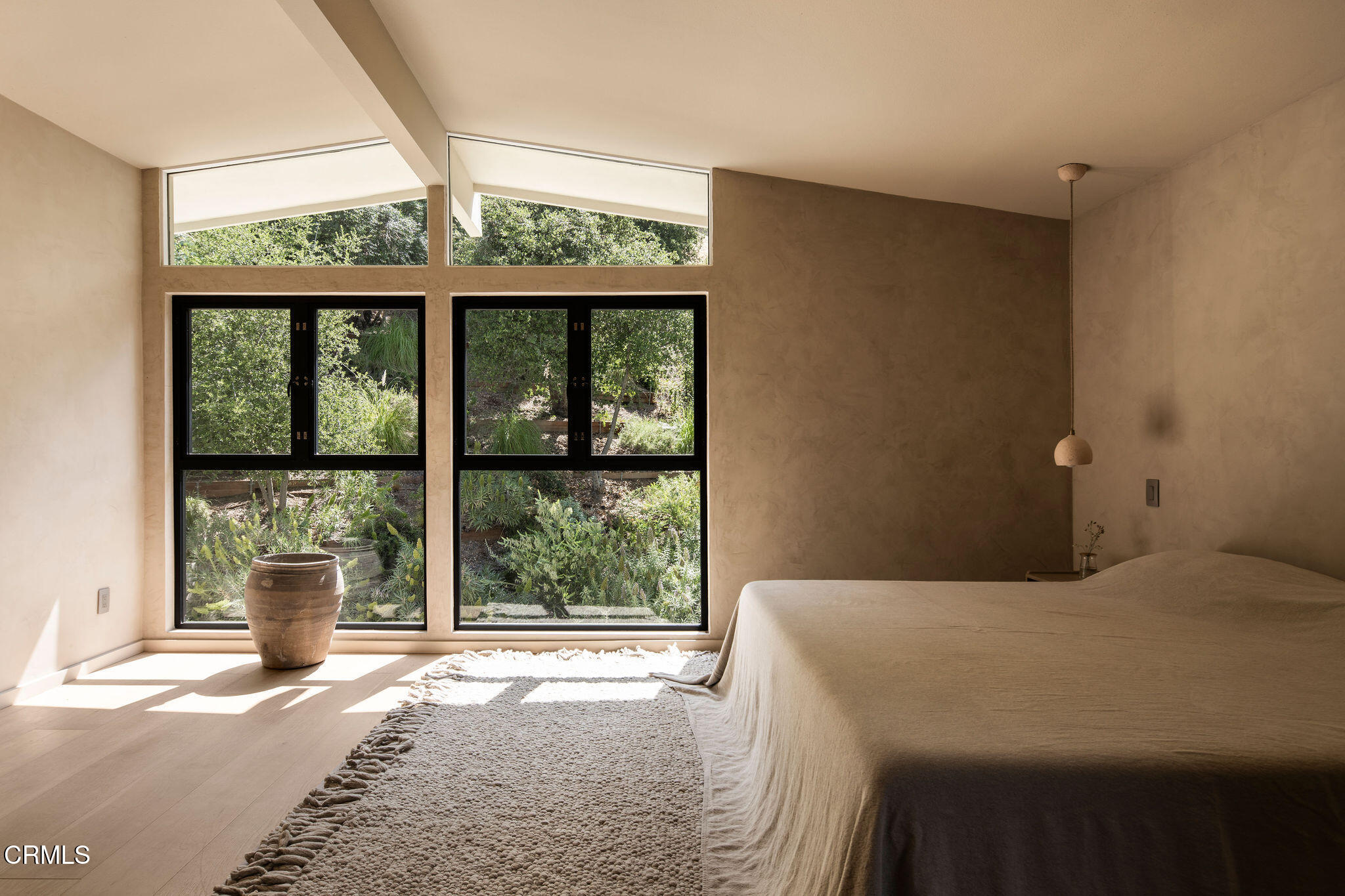 4722 Larkwood Avenue Los Angeles, CA 91364 - Photo 10 of 27 a bedroom with a large bed and a large window