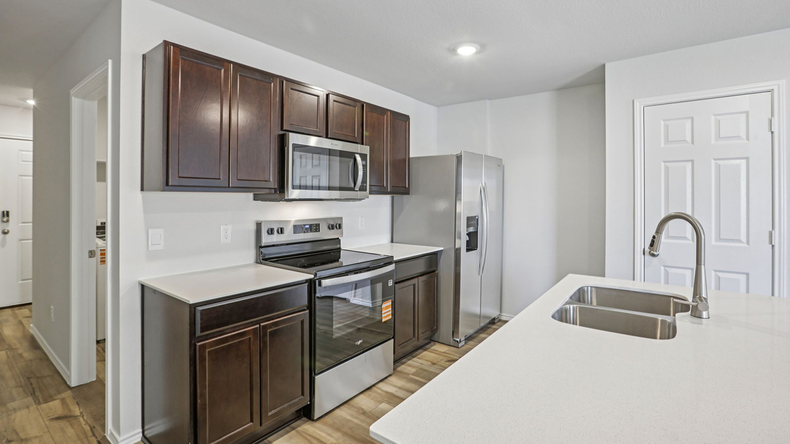 149 Wyatt Way Jarrell, TX 76537 - Photo 17 of 30 a kitchen with stainless steel appliances granite countertop a refrigerator sink and stove