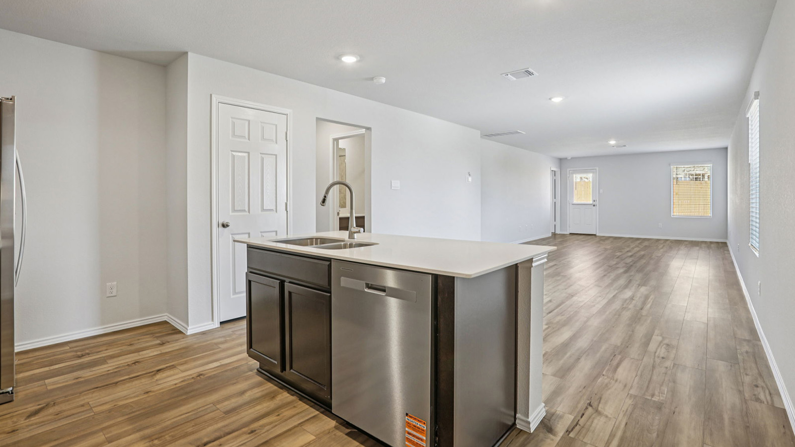 149 Wyatt Way Jarrell, TX 76537 - Photo 29 of 30 a view of a kitchen from the hallway with a sink