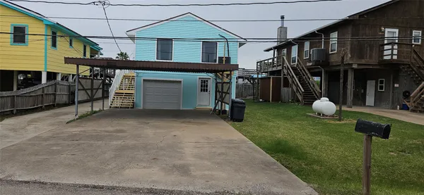 a view of a house with a backyard and porch