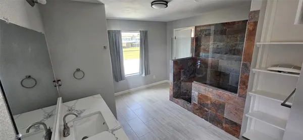 a bathroom with a bathtub and shower