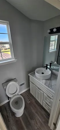 a bathroom with a sink toilet and mirror