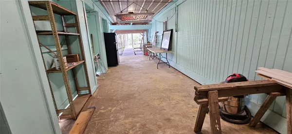 a view of a hallway with furniture and stairs