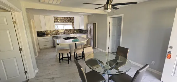 a dining room with furniture and window