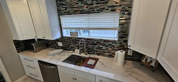 a kitchen with a stove and a refrigerator