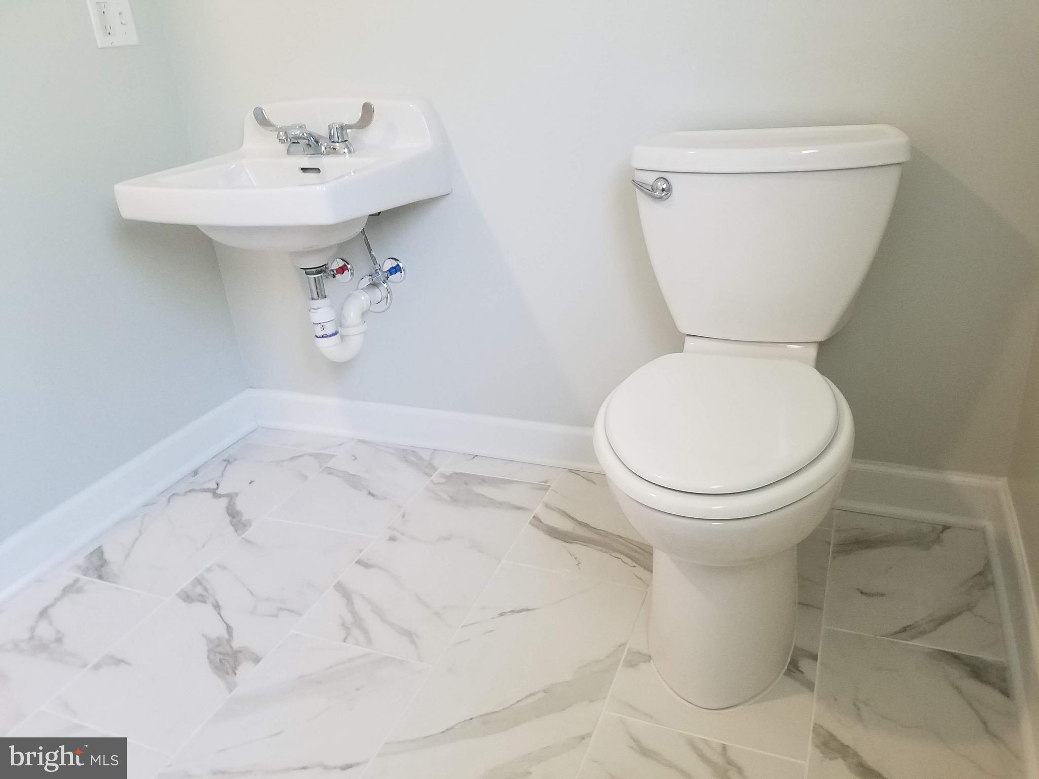 24 Cedar Crossing Red Bank, NJ 07701 - Photo 6 of 9 a bathroom with a toilet sink and mirror