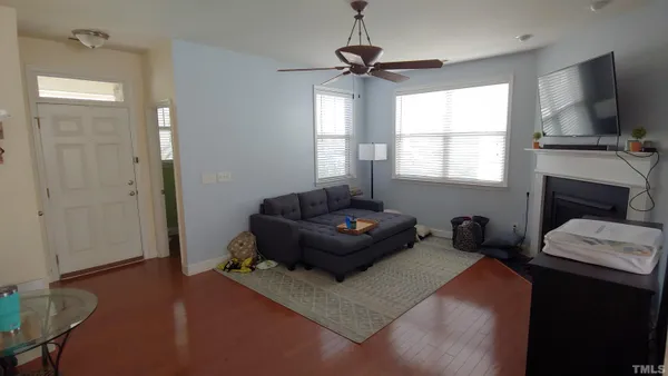 a living room with furniture a flat screen tv and a fireplace