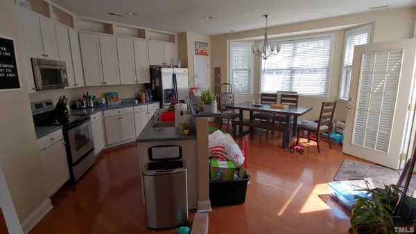 a view of a kitchen with dining table and chairs