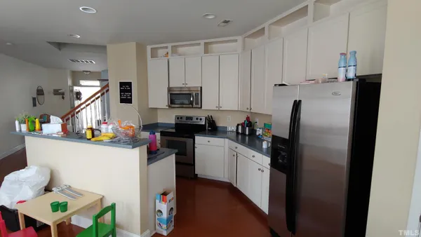 a kitchen with refrigerator and cabinets