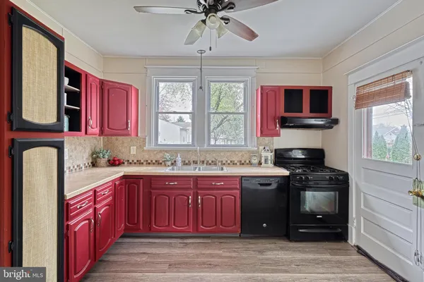a kitchen with stainless steel appliances granite countertop a stove sink and cabinets