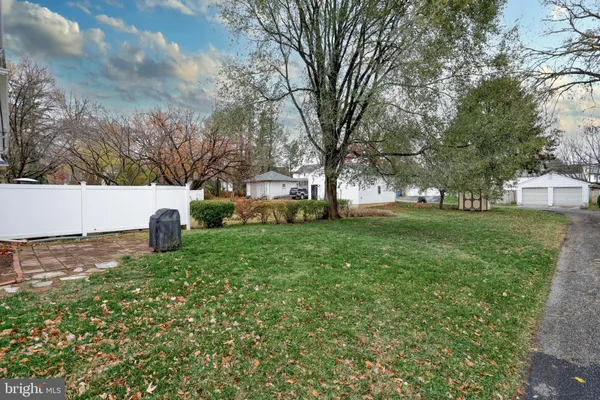 a view of a backyard with large trees