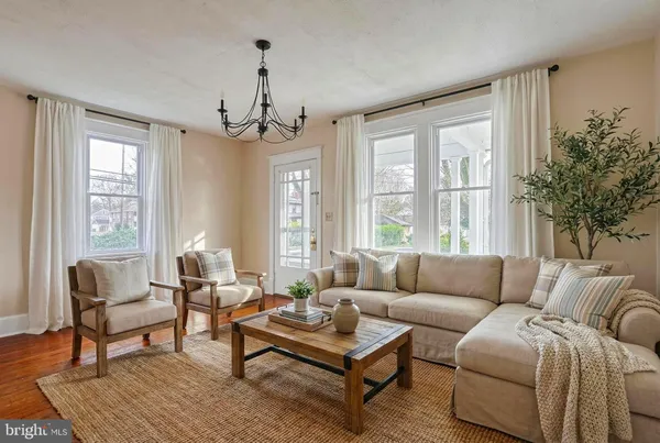 a living room with furniture and a chandelier