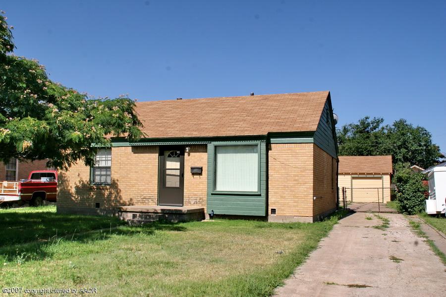3602 South Hughes Street Amarillo, TX 79110 - Photo 1 of 1 a front view of a house with a garden and garage