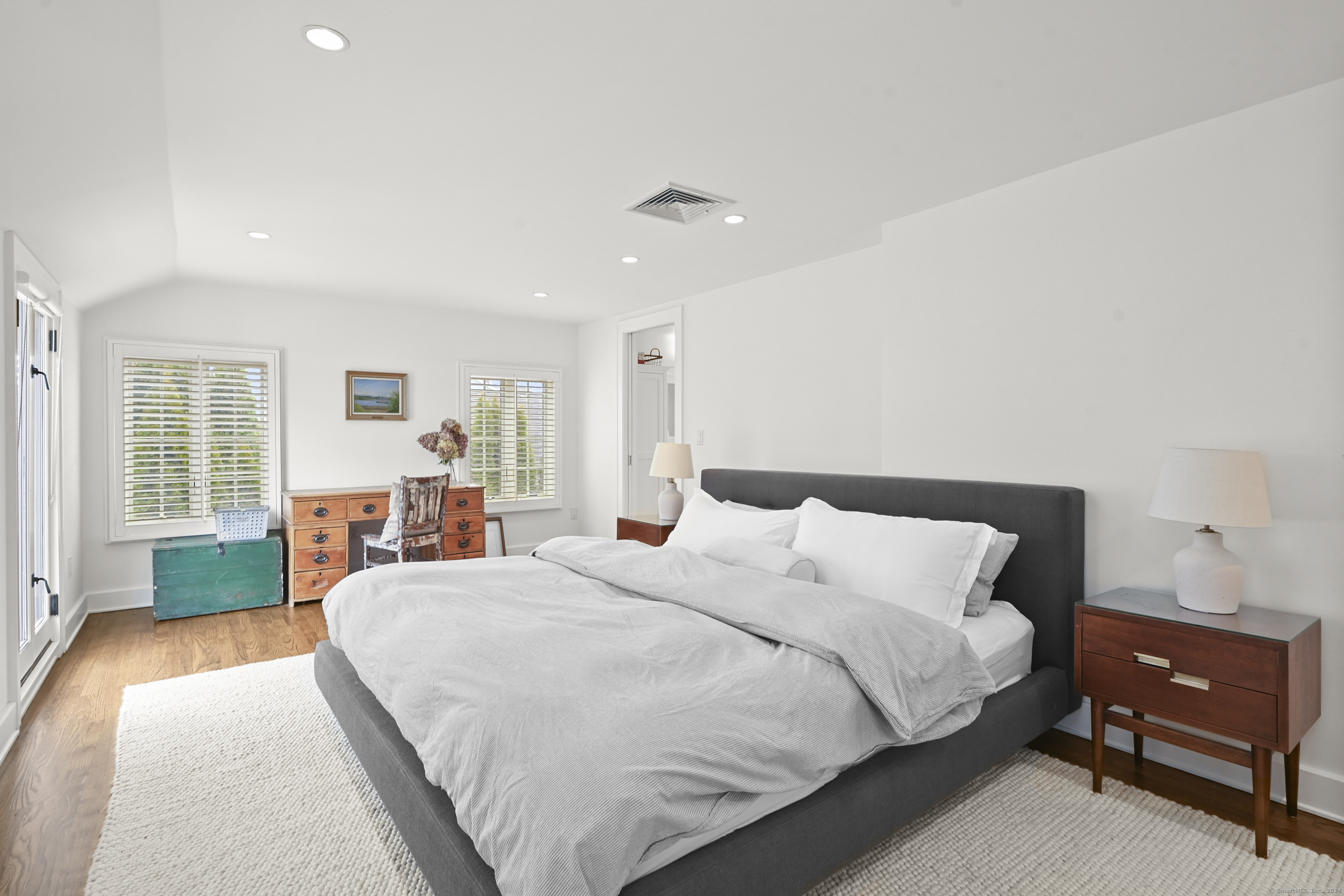 104 Roton Avenue Norwalk, CT 06853 - Photo 19 of 40 a spacious bedroom with a bed and a dresser next to a window