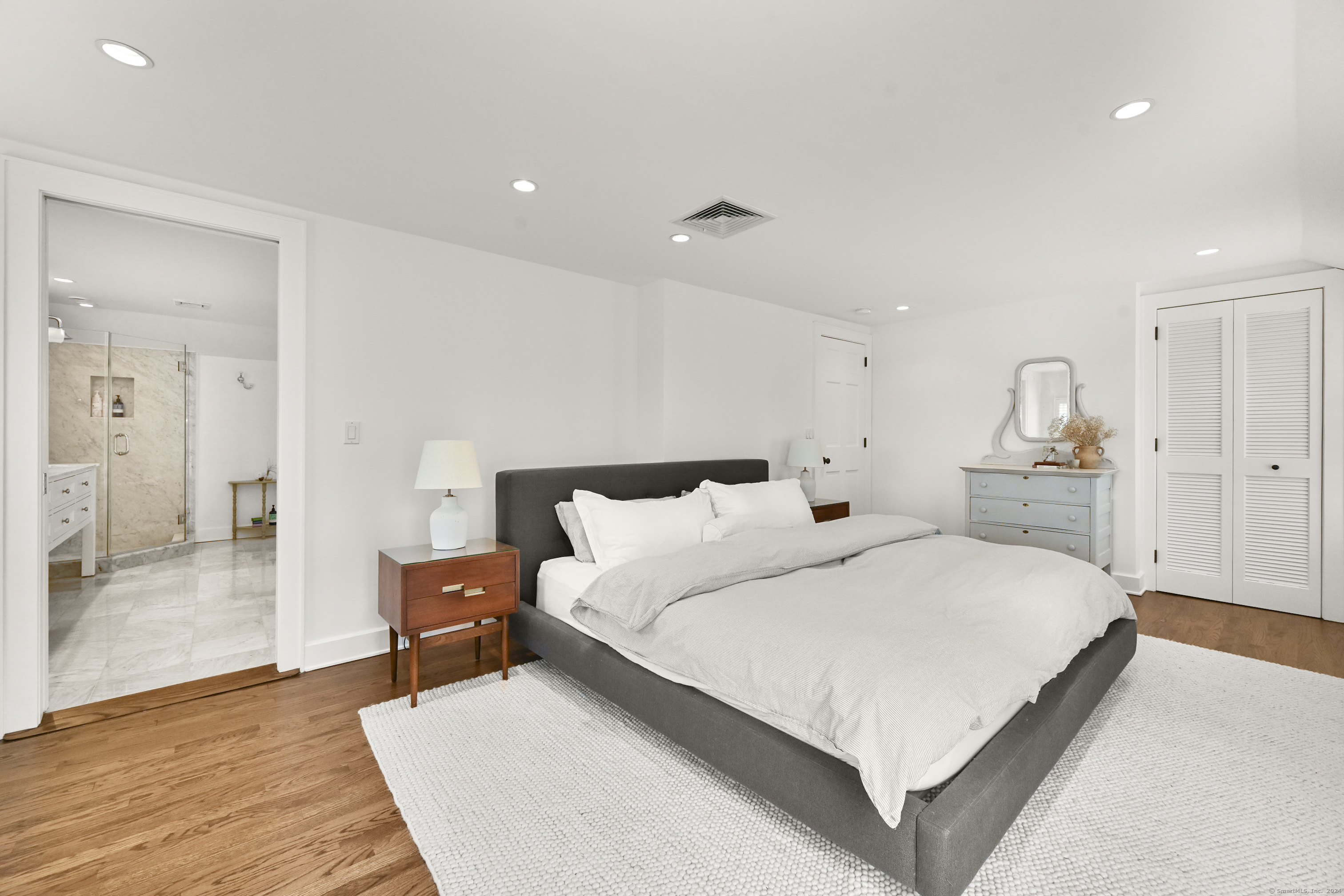 104 Roton Avenue Norwalk, CT 06853 - Photo 21 of 40 a large bedroom with a bed and a table