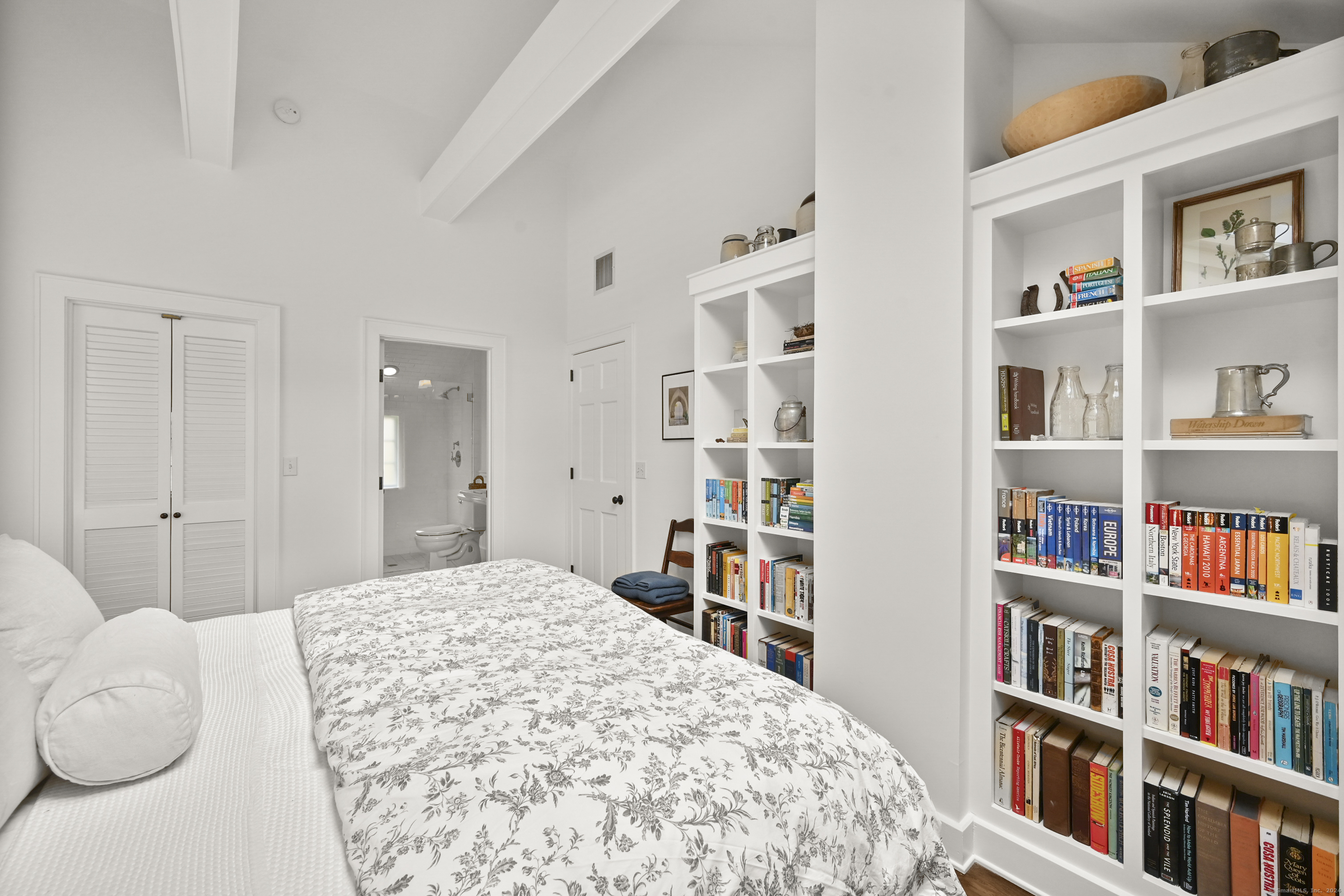 104 Roton Avenue Norwalk, CT 06853 - Photo 26 of 40 a bedroom with a bed and a book shelf