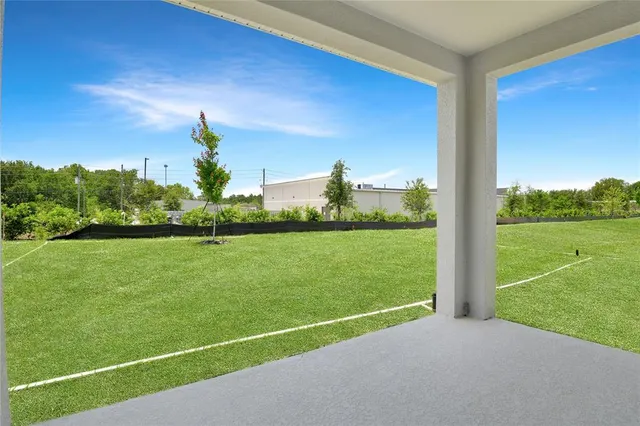 a view of a field with grass and a small yard