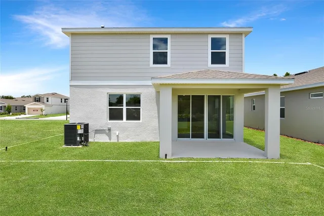 a house view with a sitting space and garden