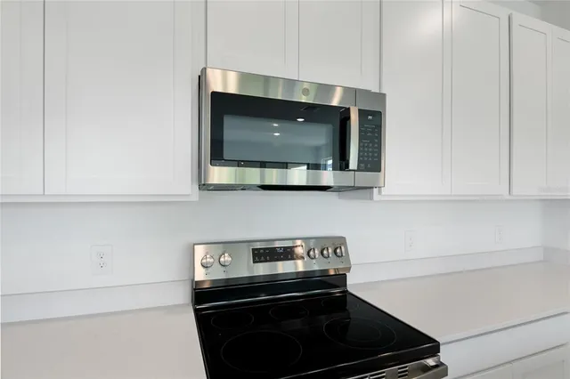 a kitchen with a stove and a microwave