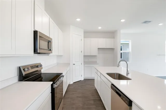 a kitchen that has a sink and a stove
