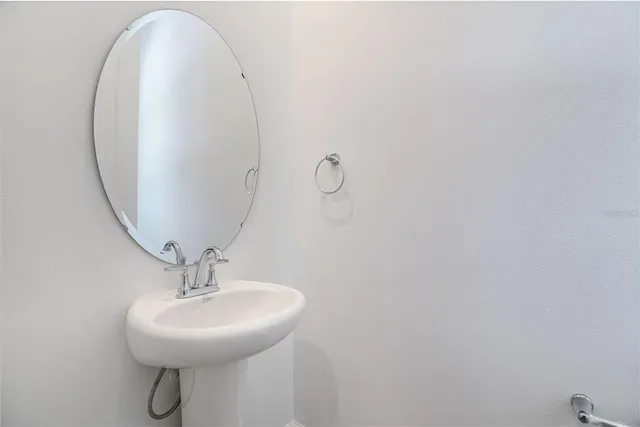 a bathroom with a sink and mirror