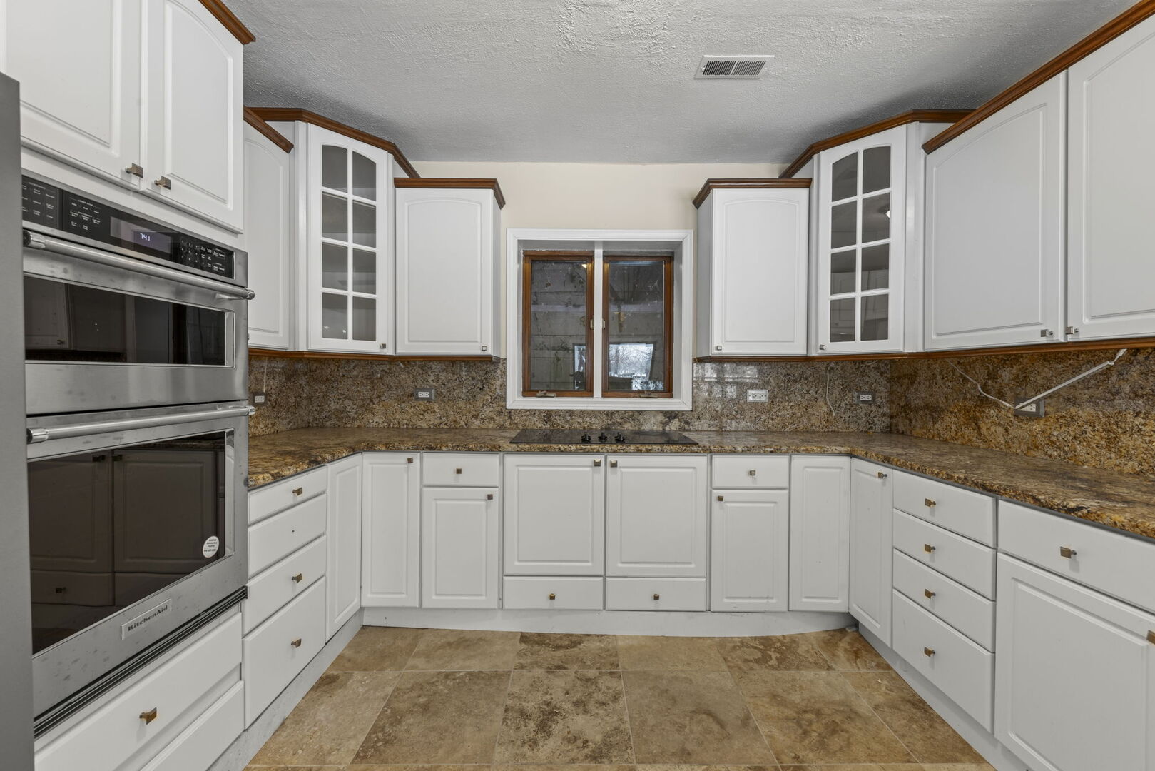 338 Hiawatha Drive Lake In The Hills, IL 60156 - Photo 11 of 49 a kitchen with granite countertop white cabinets stainless steel appliances and a sink