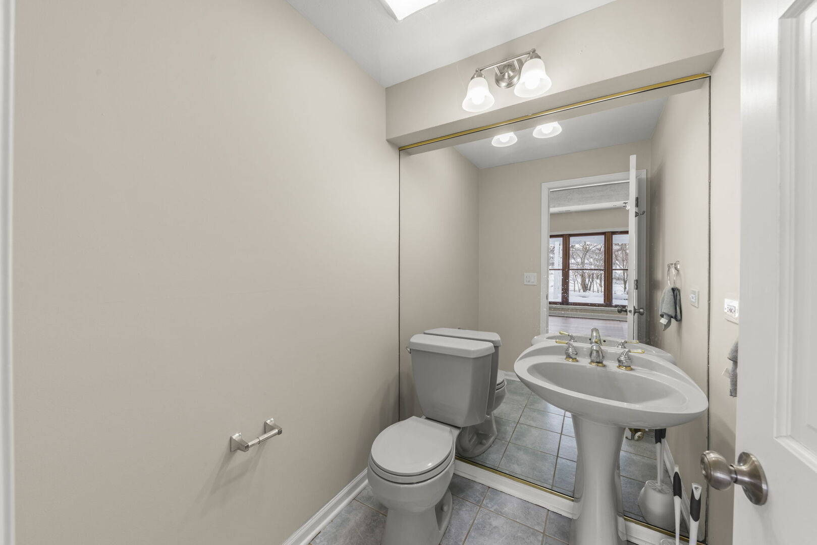 338 Hiawatha Drive Lake In The Hills, IL 60156 - Photo 13 of 49 a bathroom with a toilet sink and mirror