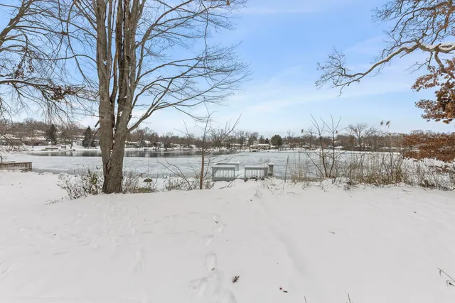a view of yard covered with snow in front of house