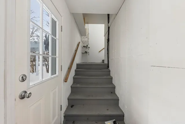 a view of staircase with white walls