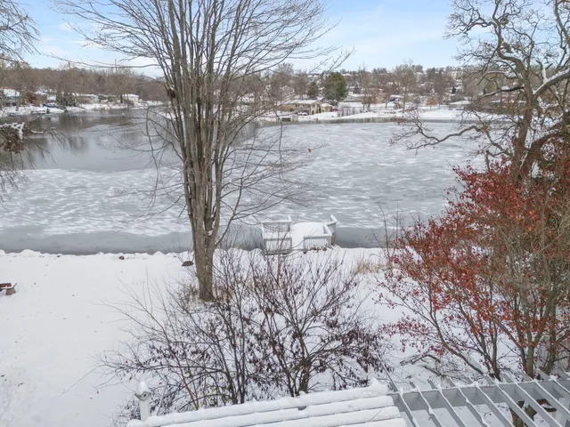 a view of yard covered with snow in front of house