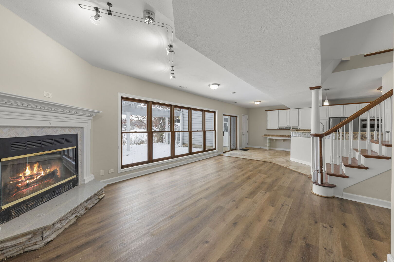 338 Hiawatha Drive Lake In The Hills, IL 60156 - Photo 6 of 49 a view of an empty room with wooden floor fireplace and a window