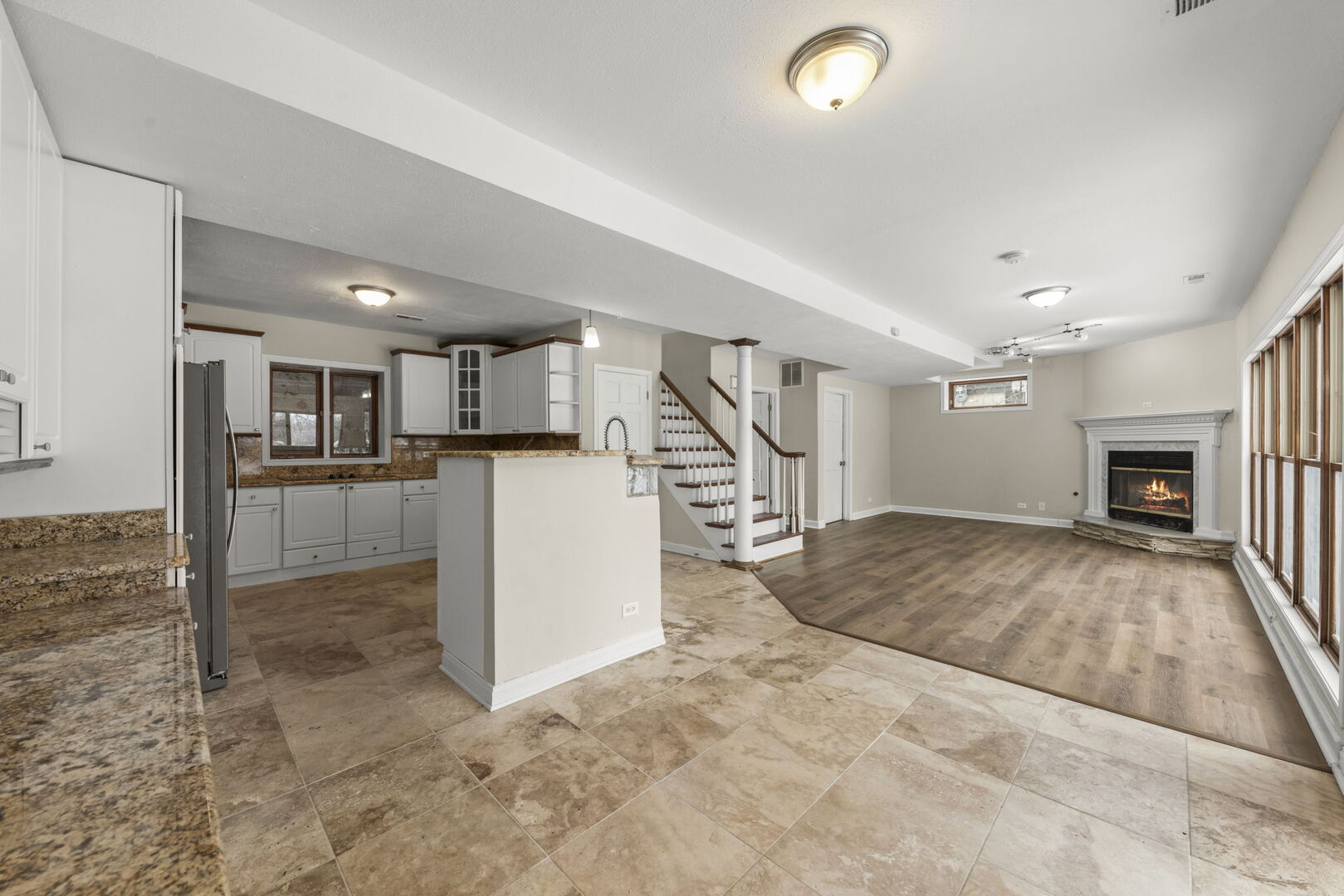 338 Hiawatha Drive Lake In The Hills, IL 60156 - Photo 8 of 49 a view of a livingroom with kitchen and fireplace