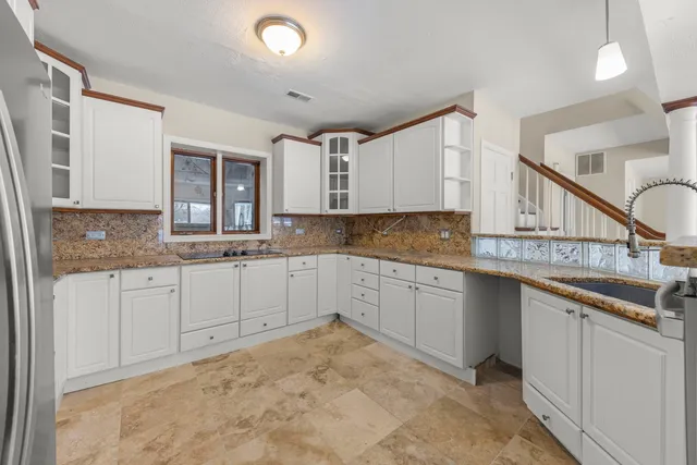 a kitchen that has a sink and cabinets in it