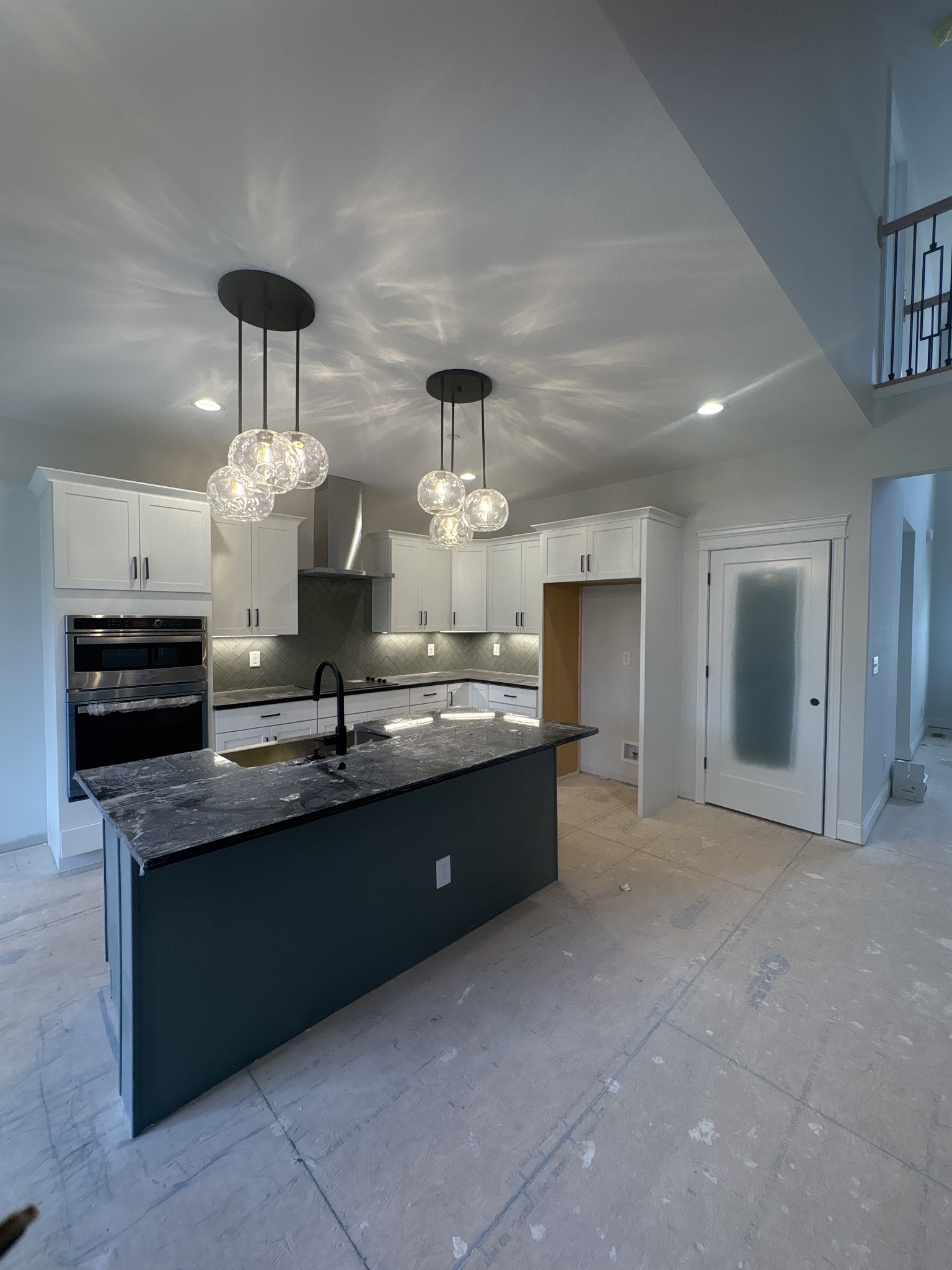 353 Young Lane Pleasant View, TN 37146 - Photo 16 of 26 a large kitchen with granite countertop a stove and a chandelier