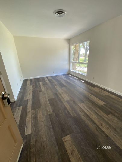 1010 Peg Street Ridgecrest, CA 93555 - Photo 3 of 17 wooden floor in an empty room with a window