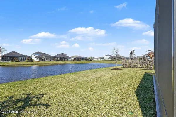 a view of a lake with houses in the back