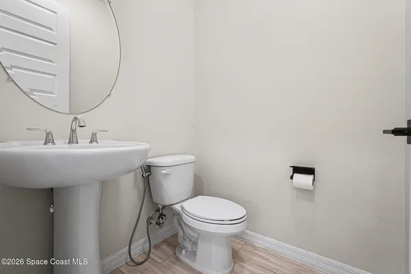 a bathroom with a sink mirror and toilet