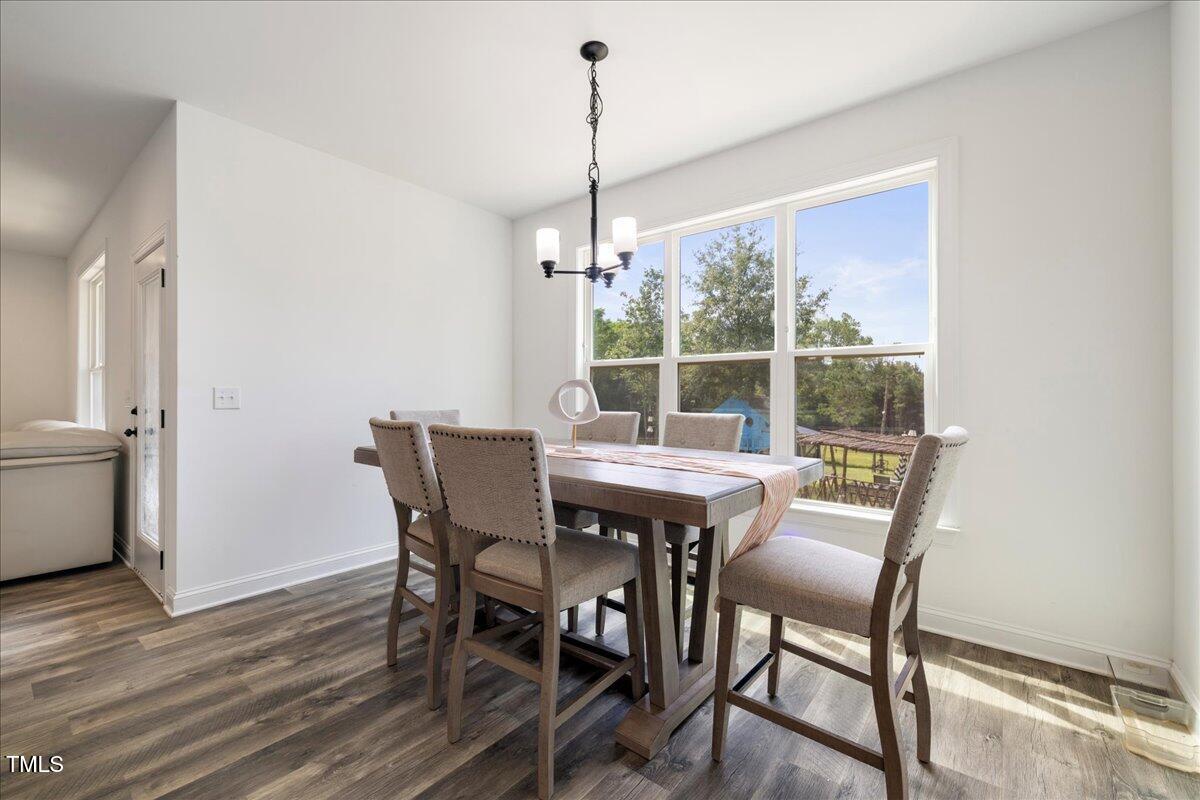 5421 West Old Spring Hope Road Spring Hope, NC 27882 - Photo 11 of 54 a view of a dining room with furniture window and wooden floor